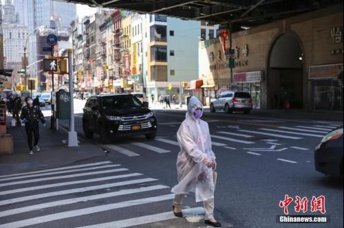 资料图：5月12日，纽约市曼哈顿唐人街，一名“全副武装”的女子正在过马路。<a target='_blank' href='http://www.chinanews.com/'>中新社</a>记者 马德林 摄