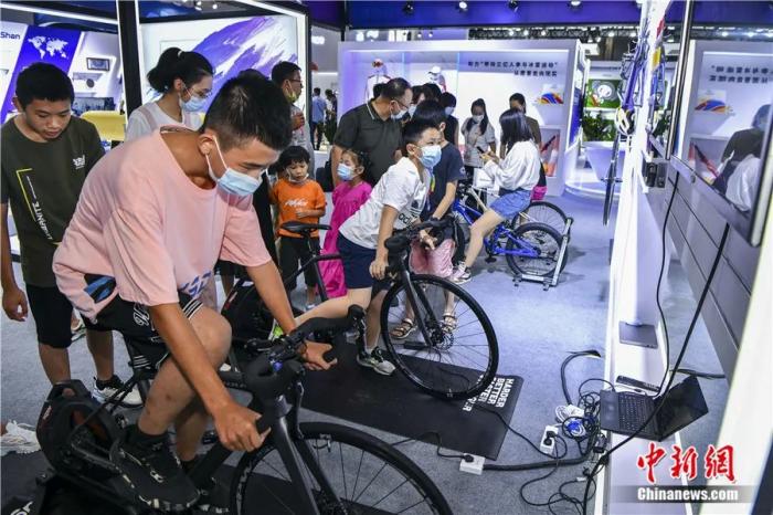 2022年7月29日，海南海口第二届中国国际消费品博览会上，民众体验自行车模拟训练器。本届消博会共有来自61个国家和地区，超2800个国内外品牌参展。<a target='_blank' href='/'>中新社</a>记者 骆云飞 摄